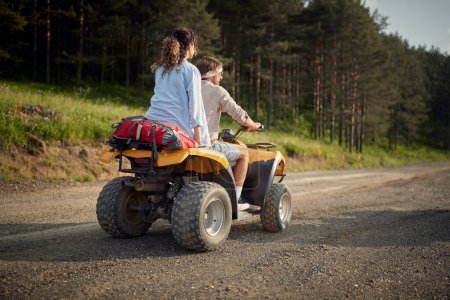Photo for Two enthusiastic friends driving quad together in the nature - Royalty Free Image