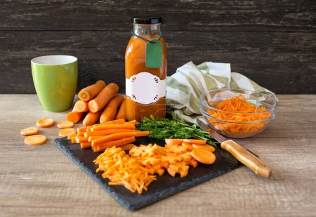 Photo for Healthy and raw carrot and carrot juice on a wooden table backgroun - Royalty Free Image