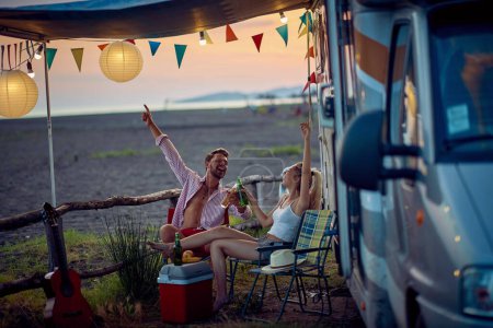 Photo for Young couple having fun camping by the sea together - Royalty Free Image