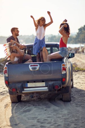 Photo for Group of young friends arriving to the beach while having roadtrip - Royalty Free Image