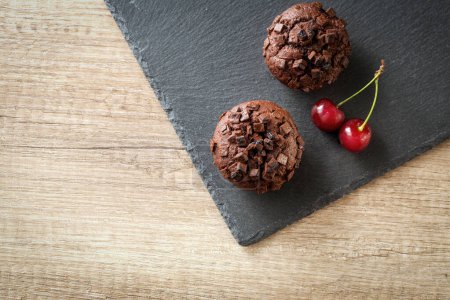 Photo for Muffins with cherry and chocolate backgroun - Royalty Free Image
