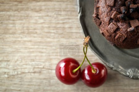 Photo for Fresh chocolate muffins with fresh cherry close up - Royalty Free Image