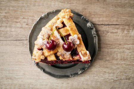 Photo for Top view slice cherry pie and fresh red cherry on plat - Royalty Free Image