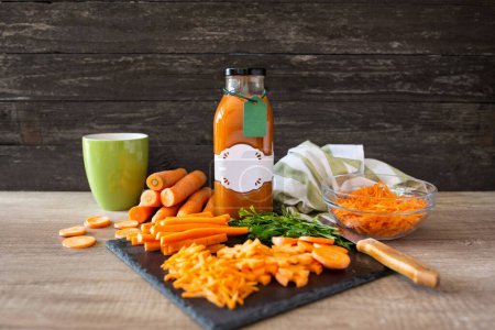 Photo for Nutrient organic and raw carrot and carrot juice on a wooden table backgroun - Royalty Free Image