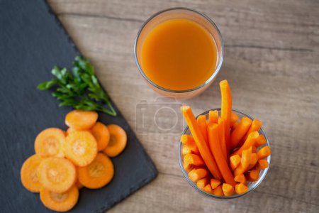 Photo for Fresh slices of carrots and carrot juic - Royalty Free Image