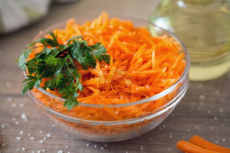 Photo for Carrot salad in salad bowl on the table. Carrots and greens. Carrots for breakfas - Royalty Free Image