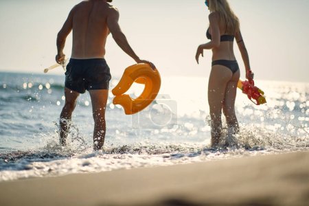 Téléchargez les photos : Couple sur la plage jouant en vacances d'été. Amusez-vous, amusez-vous ensemble. Vacances, été, concept de style de vie. - en image libre de droit