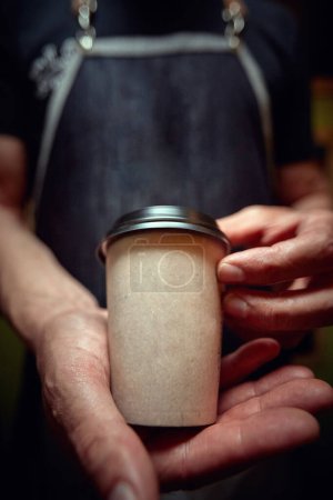 Photo for Detail of Caucasian man holding coffee in cardboard cup, showing, offering - Royalty Free Image