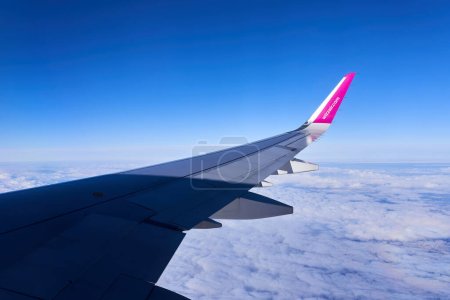 Photo for Warsaw, Poland - March 14, 2023 - A plane with the airlines logo is flying at high altitude. View from the Wizzair Airbus plane - Royalty Free Image