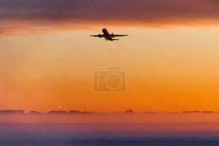 The plane is landing at dawn in heavy fog in winter