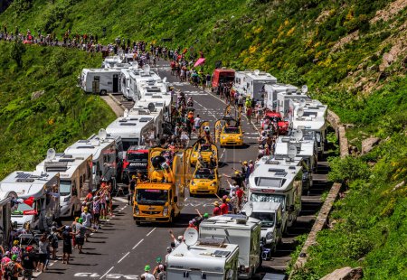 Foto de Pas de Peyrol, France - July 6,2016: BIC Caravan during the passing of the Publicity Caravan on the road to Pas de Pyerol (Puy Mary) in Cantal,in the Central Massif, during the stage 5 of Tour de France on July 6, 2016.BIC is a global company which o - Imagen libre de derechos