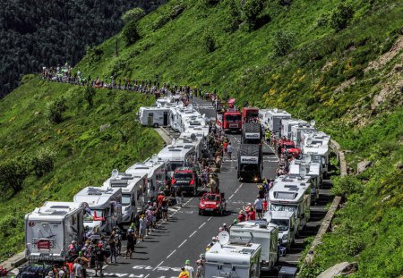 Photo for Pas de Peyrol, France - July 6,2016: Kleber Caravan during the passing of the Publicity Caravan on the road to Pas de Pyerol (Puy Mary) in Cantal,in the Central Massif, during the stage 5 of Tour de France on July 6, 2016. Kleber is a famous European - Royalty Free Image