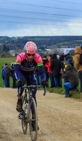 Photo for Vendome,France- March 7,2016:The Italian cyclist Matteo Bono of Lampre-Merida Team riding on a dirty road,Tertre de la Motte, in Vendome, during the first stage of Paris-Nice 2016. - Royalty Free Image