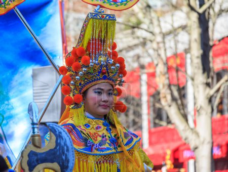 Photo for Paris, France-February 25,2018: Environmental portrait of a woman disguised as a traditional character in a float during the 2018 Chinese New year parade in Paris. - Royalty Free Image