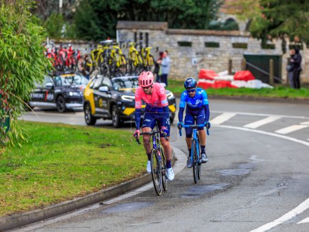 Photo for Beulle, France - March 10, 2019: The British cyclist Daniel McLay of  EF Education First Team and the Spanish cyclist Hector Carretero Milla of Movistar Team ride on Cote de Beulle during the stage 1 of Paris-Nice 2019. - Royalty Free Image