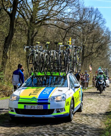 Photo for Carrefour de l'Arbre, France - April 12,2015: The car of Team Tinkoff-Saxo, driving o the famous sector Careffour de l'Arbre during Paris-Roubaix race in 2015. - Royalty Free Image