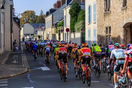 Photo for Bonneval, France - October 10, 2021: Rear view of the peloton riding in Bonneval during road cycling race Paris-Tour 2021. - Royalty Free Image