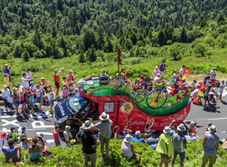 Photo for Pas de Peyrol, France - July 6,2016: Cofidis Caravan during the passing of the Publicity Caravan on the road to Pas de Pyerol (Puy Mary) in Cantal,in the Central Massif, during the stage 5 of Tour de France on July 6, 2016. Cofidis is an important Fr - Royalty Free Image