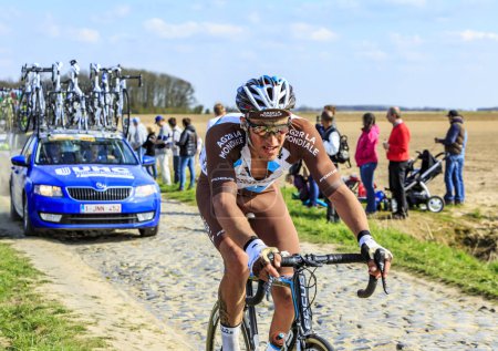 Photo for Carrefour de l'Arbre, France - April 12,2015: The French cyclist, Damien Gaudin of AG2R La Mondiale Team, riding in the peloton on the famous sector Careffour de l'Arbre during Paris-Roubaix race in 2015. - Royalty Free Image