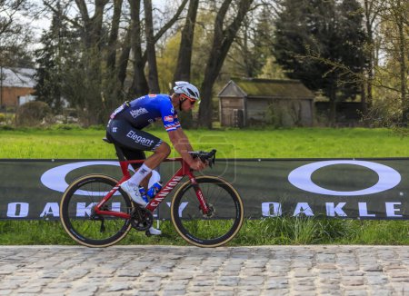 Photo for Brillon, France - April 09, 2023: The Belgian cyclist Mathieu van der Poel of the Team Alpecin-Deceuninck, the winner of the race, rides duirng Paris-Roubaix 2023. - Royalty Free Image