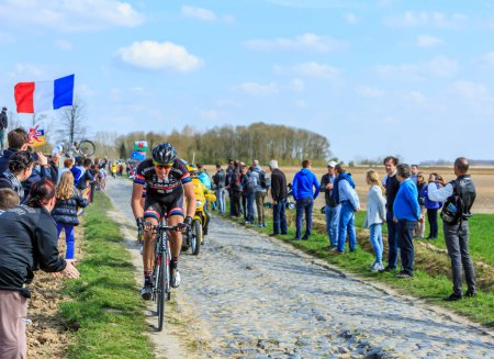 Photo for Carrefour de l'Arbre, France - April 12,2015: The Dutch cyclist Koen de Kort of Team Giant - Alpecin riding in the famous sector Careffour de l'Arbre during Paris-Roubaix race in 2015. - Royalty Free Image