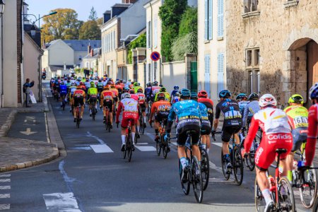 Photo for Bonneval, France - October 10, 2021: Rear view of the peloton riding in Bonneval during road cycling race Paris-Tour 2021. - Royalty Free Image