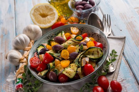 Photo for Chicken salad with zucchinis cherry tomatoes black olives and lemon - Royalty Free Image