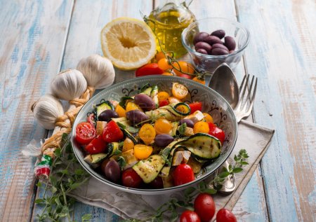 Photo for Chicken salad with zucchinis cherry tomatoes black olives and lemon - Royalty Free Image