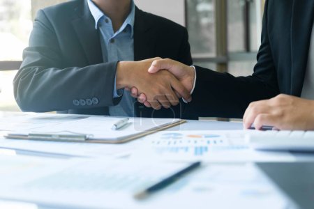 Photo for The businessman and his partnership are agree with their concept. The image of two businessman are shaking hands together. The successful persons are shaking hands after have a good deal with their - Royalty Free Image