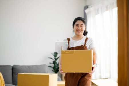 Photo for Happy single young woman moving to new home. Modern female people in moving home apartment leisure indoor activity alone. - Royalty Free Image