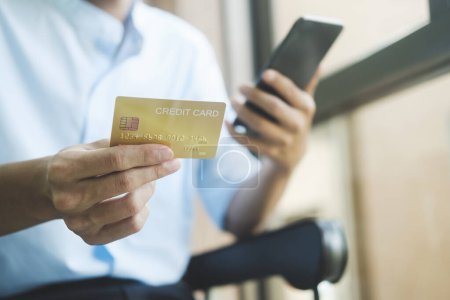 Photo for Young asian business hands holding credit card and using laptop smart phone Online shopping Website. Easy Ecommerce Website Shop Online by Smartphone.Online shopping concept. - Royalty Free Image