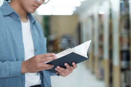 Photo for University students reading books for research and a variety of research resources in the library to support reports, assignments, papers, essays, and submissions for classes. The notion of education - Royalty Free Image