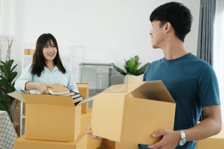 Photo for Young couple moving in new home.Couple is having fun with cardboard boxes in new house at moving day. - Royalty Free Image
