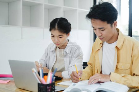 Photo for Learning, education and school concept. Young woman and man studying for a test or an exam. Tutor books with friends. Young students campus helps friend catching up and learning. - Royalty Free Image