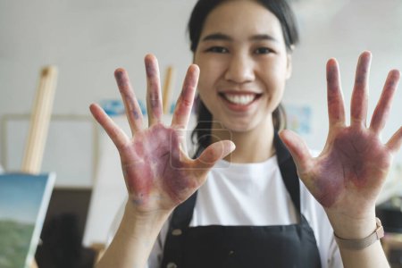 Photo for Creative portrait, woman hands with paint on happy art school student and oil painting inspiration for Indian girl. Fun learning color theory and young artist creativity in university workshop studio - Royalty Free Image