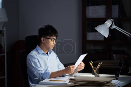 Photo for Businessman working hard overtime at night at the office. He felt tired and stressed from work. - Royalty Free Image