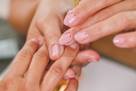 Photo for Cropped image of an unrecognizable woman enjoy oil treatment for her cuticles during manicure in a beauty salon. - Royalty Free Image