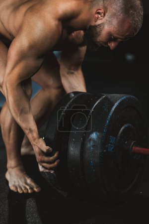 Photo for Close-up of a strong muscular man getting ready to weightlifting at the gym. - Royalty Free Image