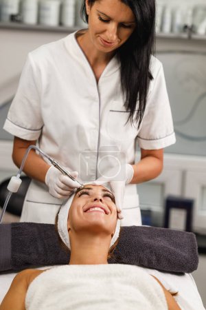 Photo for Shot of a beautiful young woman on a microdermabrasion facial treatment at the beauty salon. - Royalty Free Image
