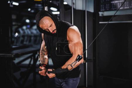 Photo for Shot of a young fitness man doing hard training for his chest muscles on a gym machine. - Royalty Free Image
