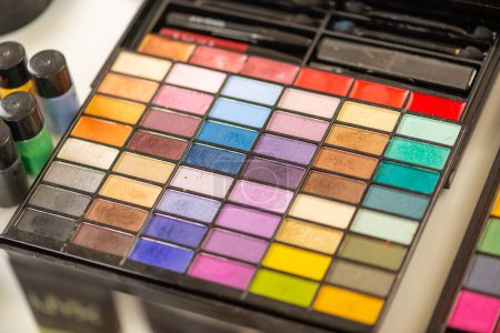 Photo for Palette with multicolored eyeshadows  on a table of a make-up artist. - Royalty Free Image
