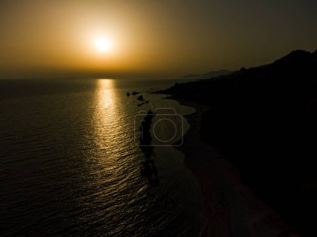 Photo for Aerial view of the wild beaches with rocks in the sea or ocean at the sunset. - Royalty Free Image