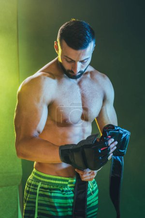 Photo for Studio shot of a muscular shirtless man showing his perfect muscles after boxing working. - Royalty Free Image