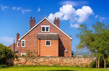 Téléchargez les photos : Maison traditionnelle anglaise en brique rouge à la campagne - en image libre de droit