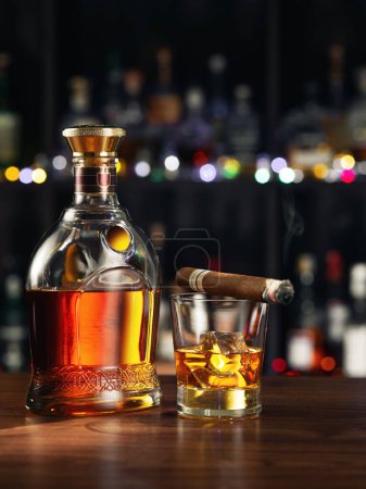 Téléchargez les photos : Close up view of cigar, bottle of rum and glass aside on color back. - en image libre de droit