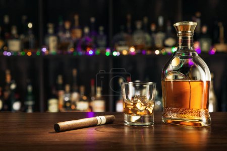 Photo for NO LOGOS OR TRADEMARKS!  SELF MADE LABELS! close up view of cigar, bottle of whiskey and a glasess aside on color back. - Royalty Free Image