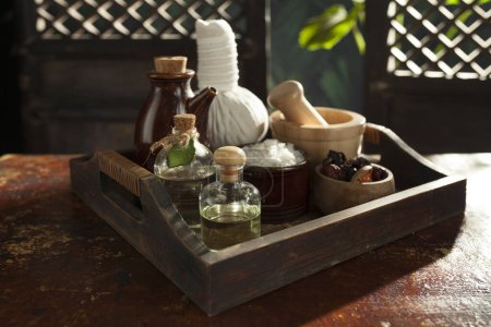 Téléchargez les photos : Close up view of herb, salt, oil and Herbal Compress on color back. - en image libre de droit