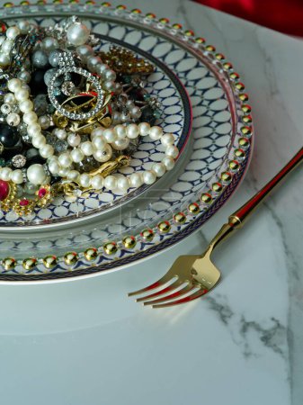 Photo for Close up view of different sorts of jewelry is on the plate ready to be eaten - Royalty Free Image