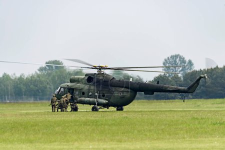 Photo for Landing of a squad of soldiers from a helicopter - Royalty Free Image