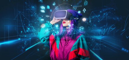 Photo for Concept of stylish woman in VR glasses with future interface on dark background - Royalty Free Image
